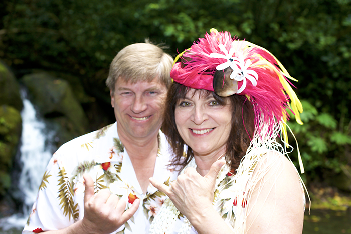 Couple celebrating their 25 year vow renewal in front of a waterfall