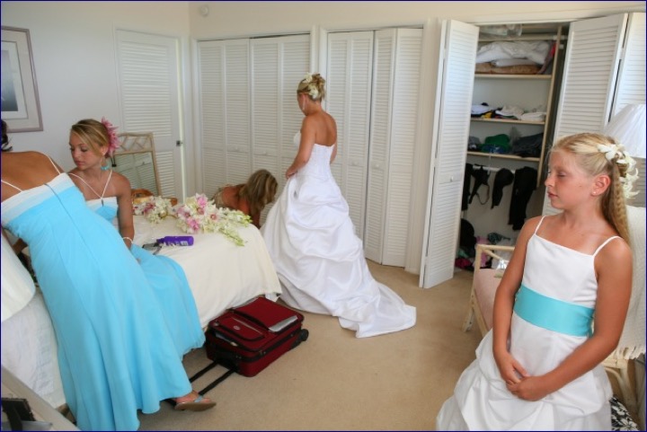 Angela in her gown with her bridesmaids in turquoise inside the estate house