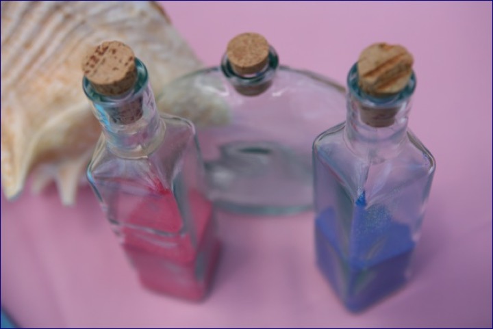 Turquoise and pink sand in glass bottles for the sand ceremony
