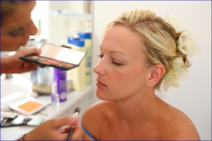 Angela having her makeup done before the wedding