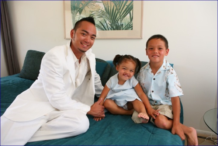 Chris with two of the children on the sofa in the estate house