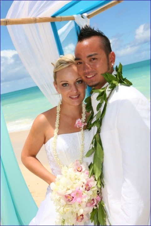 Close up of Angela and Chris with her orchid bouquet