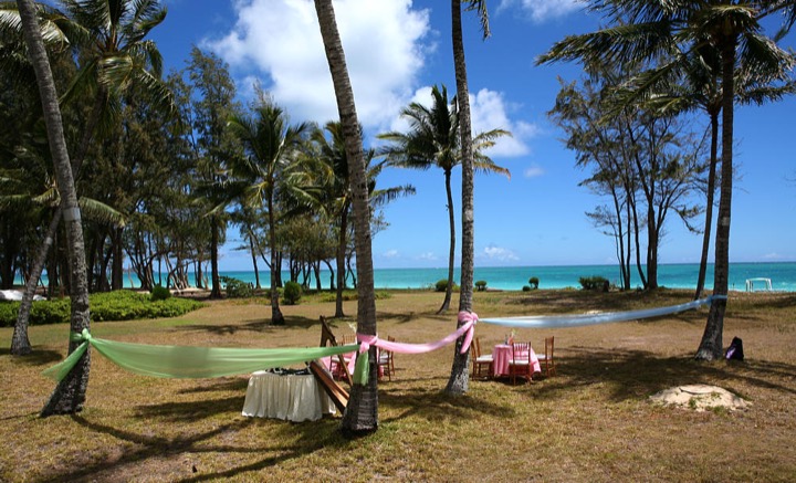 Harp and chairs set out on the beach at the estate with the ocean behind