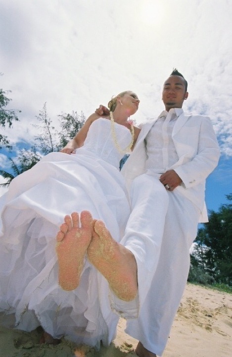 Sandy bare feet as the couple sits together on the beach