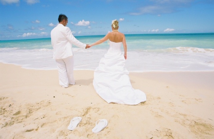 Chris and Angela walking hand in hand along the water