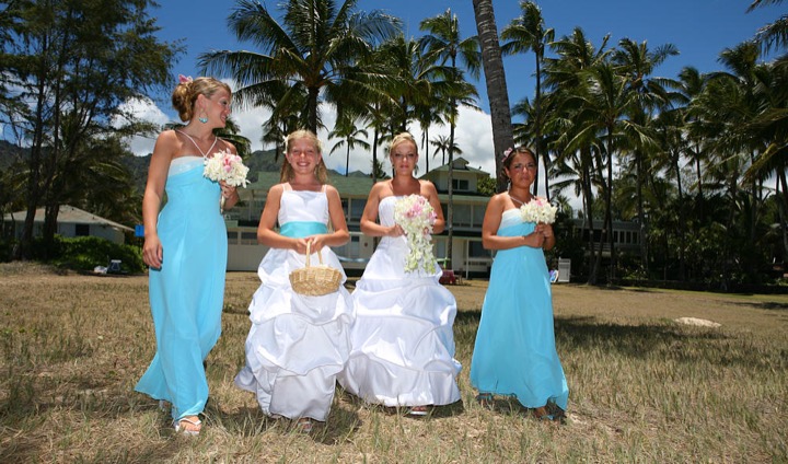 Angela and her bridesmaids walking to their wedding on the beach