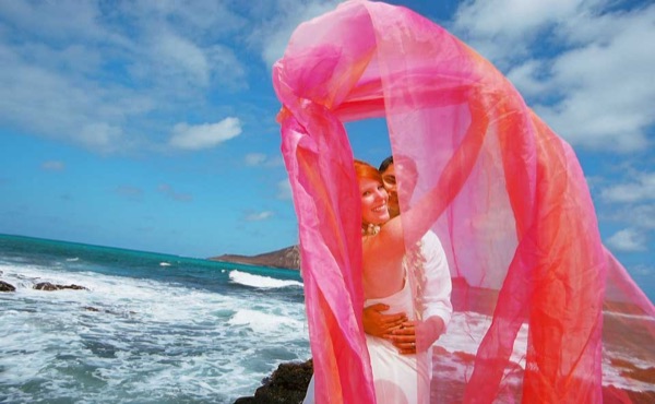 Ashley playing with rainbow chiffon on the cliffs after ceremony, from another angle