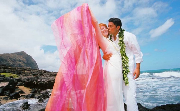 Ashley playing with rainbow chiffon on the cliffs after ceremony, laughing together