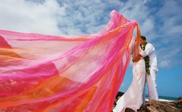 Ashley playing with rainbow chiffon on the cliffs after ceremony, close up