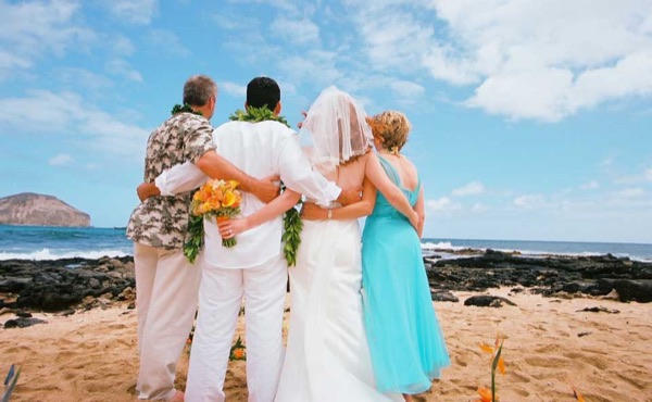 The groom with Ashley on the rocks at Makapuu