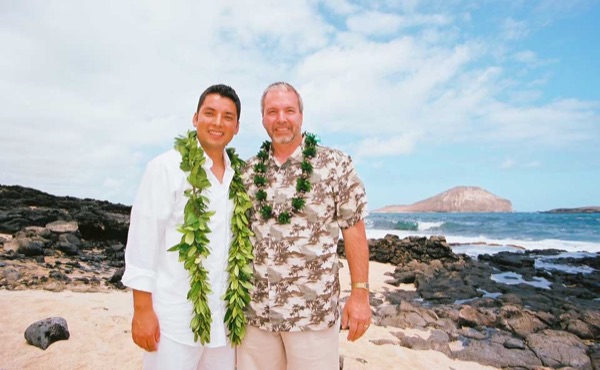 The groom with Ashley's father, smiling