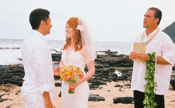 Ashley and her groom during the ceremony by the lava rocks, from another angle