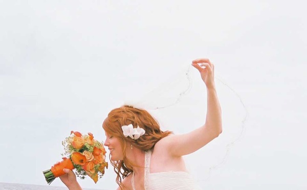 Ashley's wedding ceremony on the beach, smiling