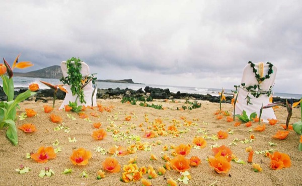 Ashley and her groom during the ceremony by the lava rocks, smiling