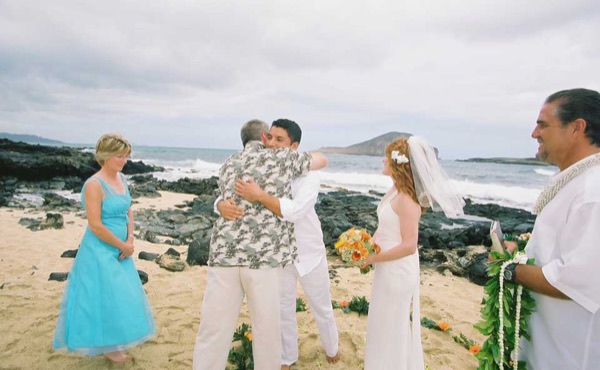 The aisle of orange flowers by the sea, laughing together