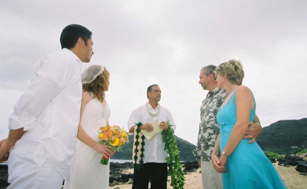 Ashley and her groom during the ceremony by the lava rocks, laughing together