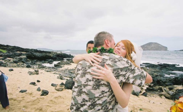 Ashley's wedding ceremony on the beach, side by side