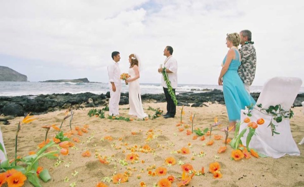 Ashley and her groom during the ceremony by the lava rocks, side by side