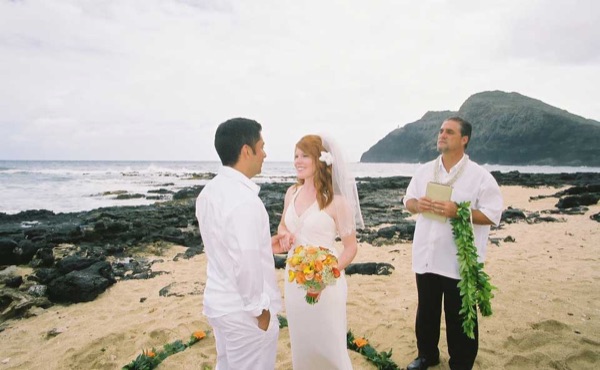 Ashley's wedding ceremony on the beach, in a happy moment