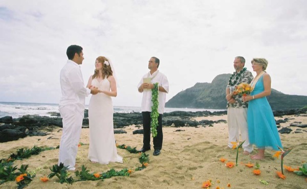 Ashley and her groom during the ceremony by the lava rocks, in a happy moment