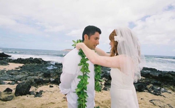 The aisle of orange flowers by the sea, looking at each other