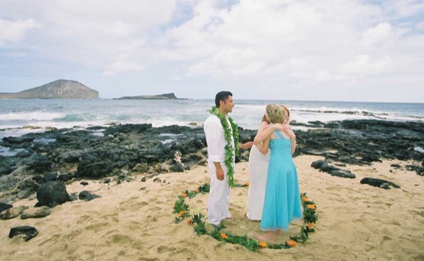 The aisle of orange flowers by the sea, under a blue sky