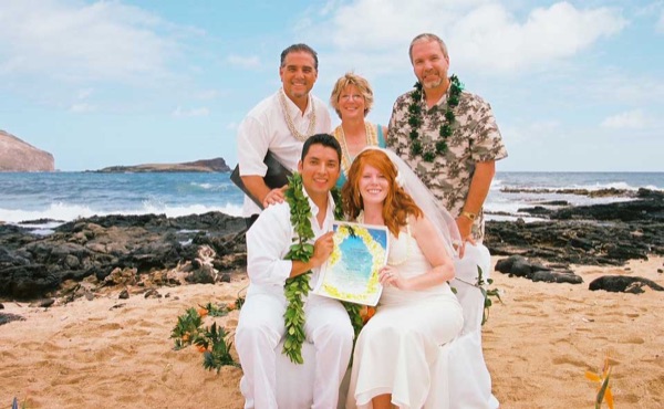 Ashley and her groom during the ceremony by the lava rocks, close together