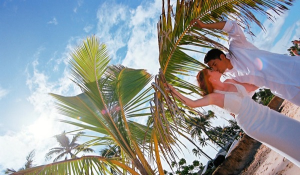 A kiss under the palms at Lanikai, smiling