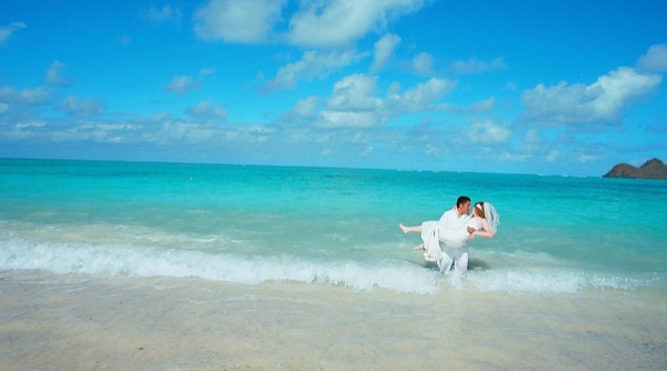Ashley and her groom in the water at Lanikai, from another angle