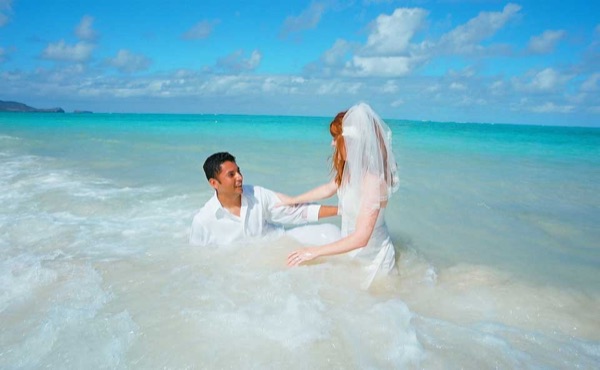 Going into the water for Ashley's trash the dress shoot, laughing together