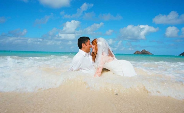 A kiss under the palms at Lanikai, laughing together