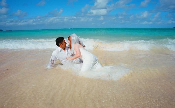 Going into the water for Ashley's trash the dress shoot, under a blue sky