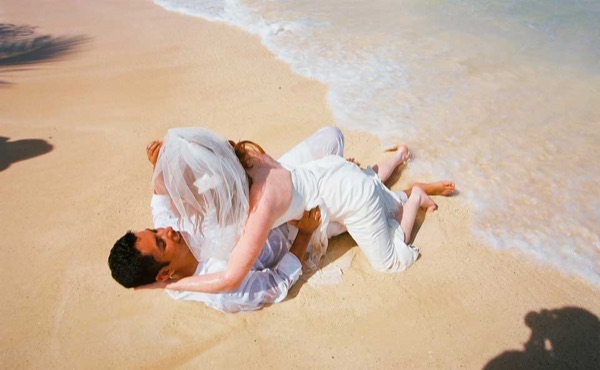 Ashley and her groom in the water at Lanikai, side by side