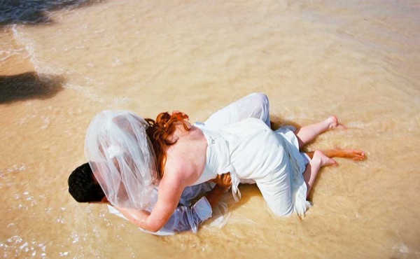 A kiss under the palms at Lanikai, side by side