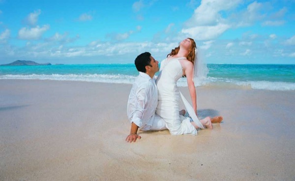 Ashley and her groom in the water at Lanikai, in a happy moment
