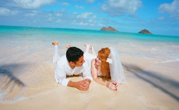 A kiss under the palms at Lanikai, looking at each other