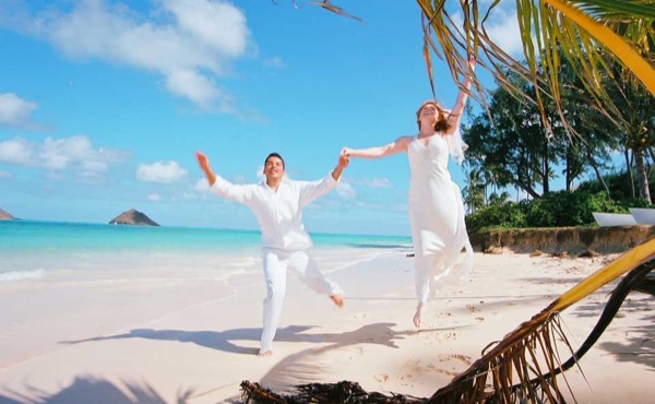Kissing the wedding couple after vows at Lanikai beach