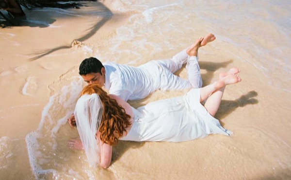 Legs on the beach of love with Ashley and her groom, smiling