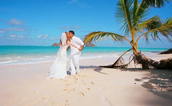 The groom twirling Ashley at Lanikai, close up
