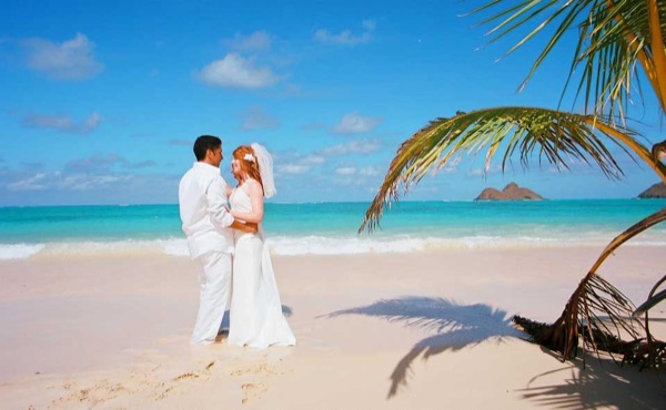 The groom twirling Ashley at Lanikai, from another angle