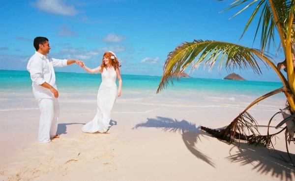 The groom twirling Ashley at Lanikai, in the sunshine