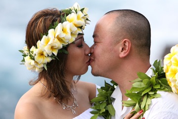 Christy and Ray at their yellow plumeria beach wedding
