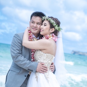 Marsha and Patrick holding each other on the beach after their vows