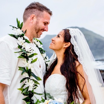 The bride and groom smiling at each other after their Makapuu wedding