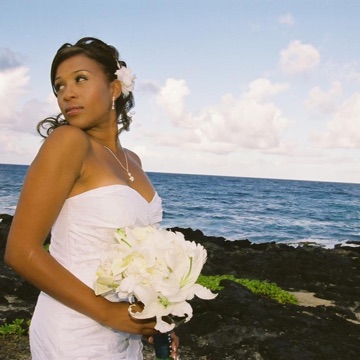 Jamillah in her wedding dress by the ocean