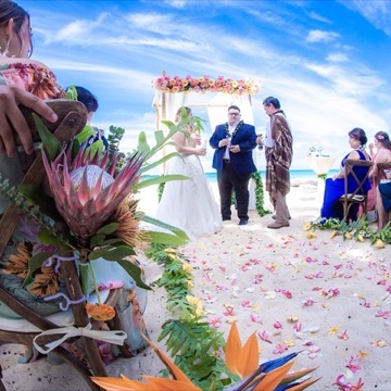 Lauren and Johnathan under the hibiscus archway