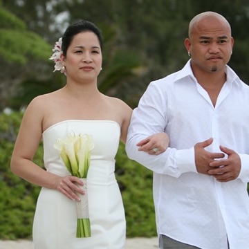 Jo and Rey walking together at their Kailua estate wedding