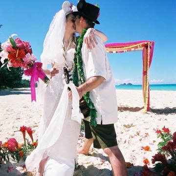 Diane and Ryan in his top hat with Mickey Mouse ears on the beach