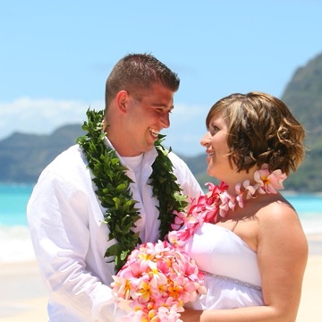 Justin and Jill smiling together in their leis