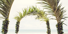 Hawaii beach wedding in Waimanalo setting with tiki men and flowers from the island of Oahu